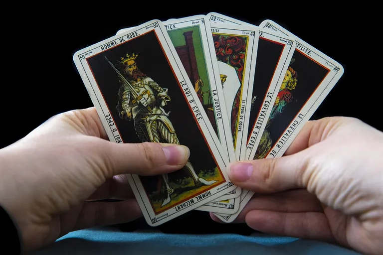 A tarot reader holding tarot cards